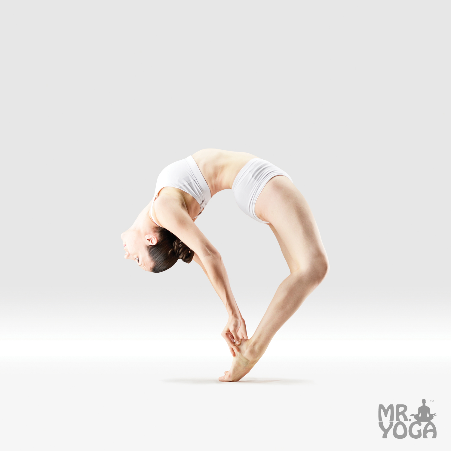 Young woman doing upward bow yoga pose, wheel position Stock Photo - Alamy